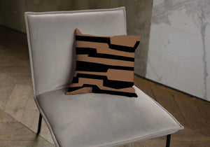 Brown and black pillow with labyrinth pattern